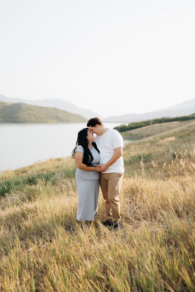 Mom and dad touching nose to nose for their family pictures.